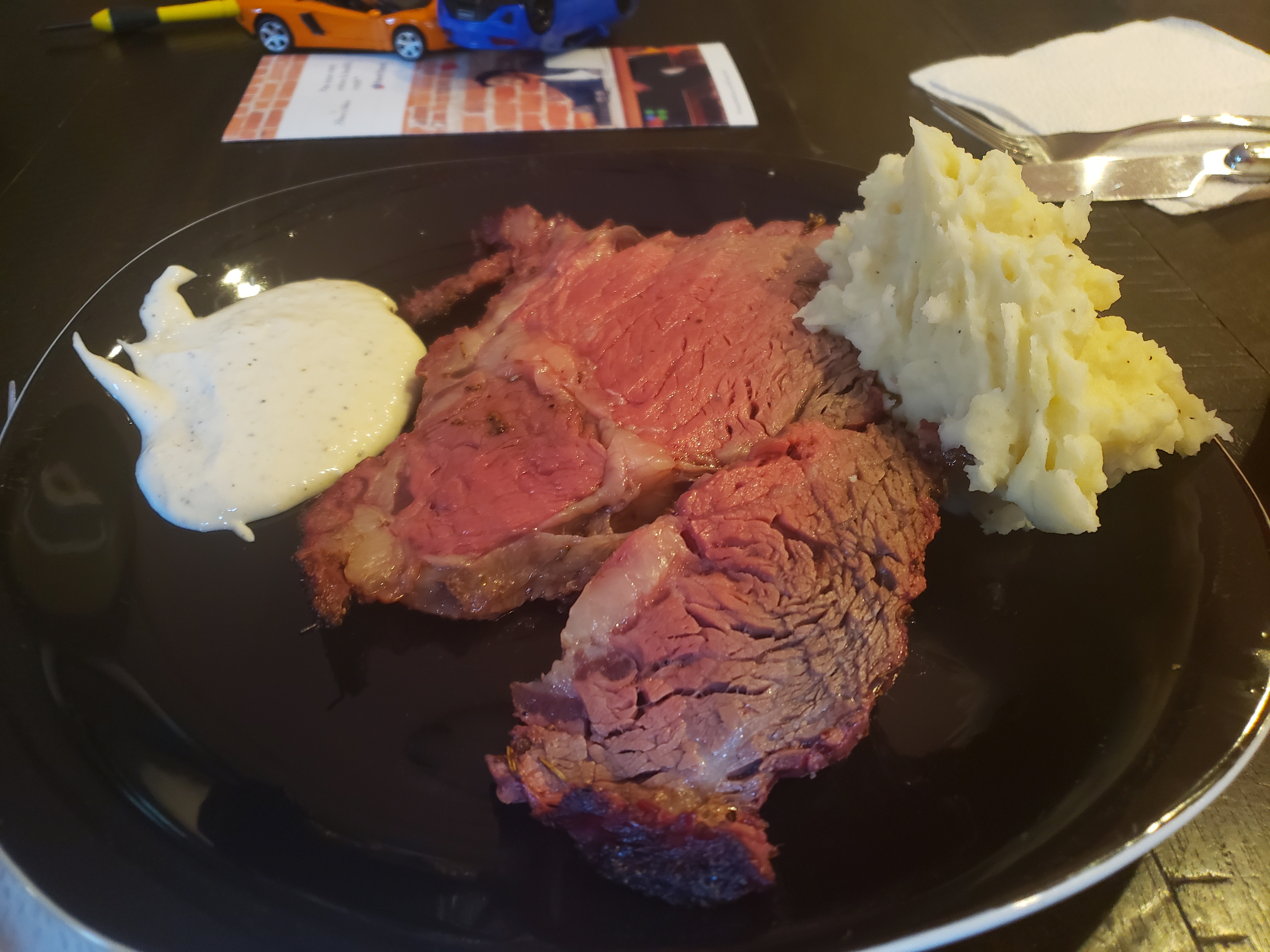 Smoked prime rib served with potatoes and horseradish sauce