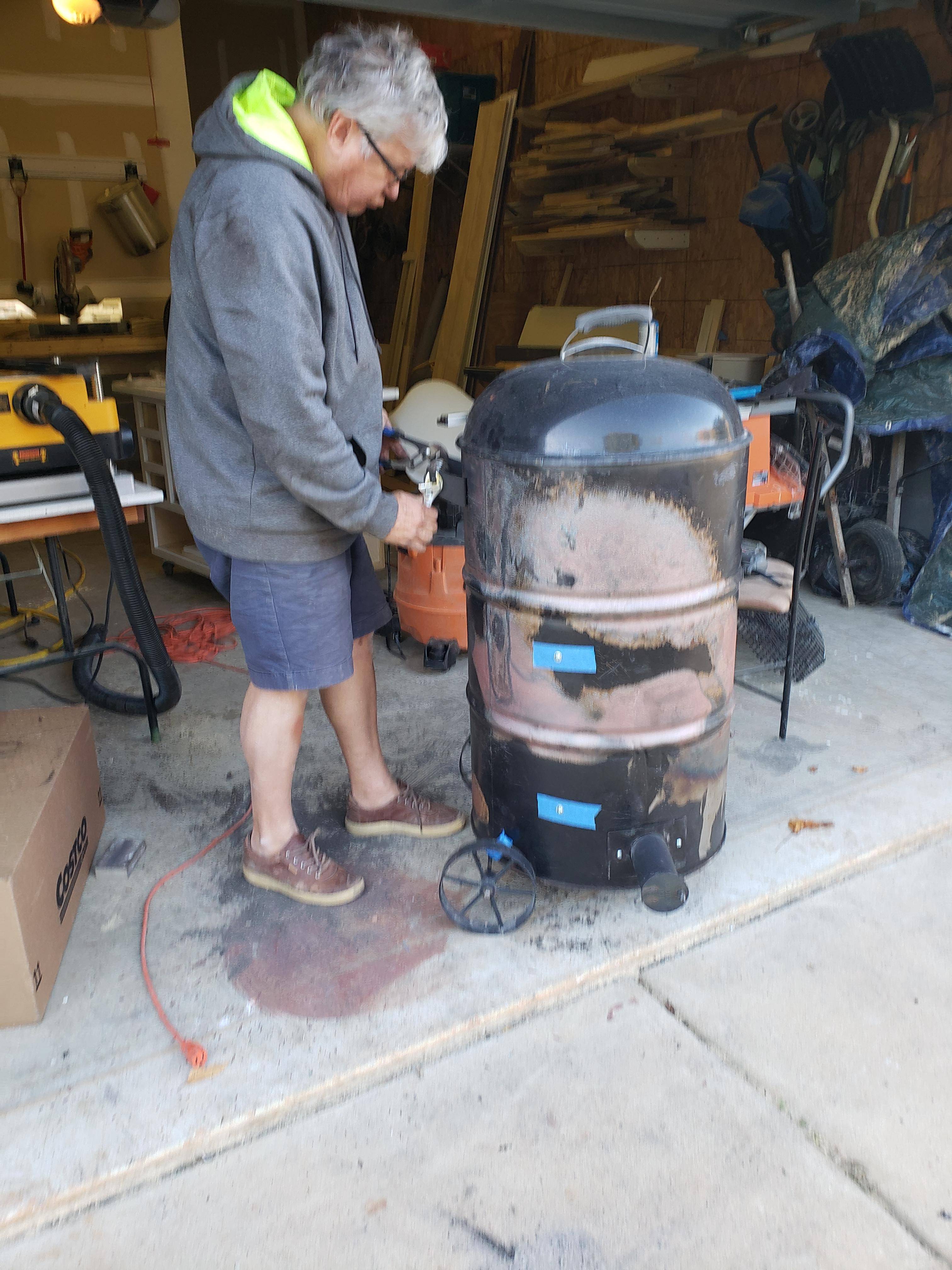 My dad bending the smoker handle to fit